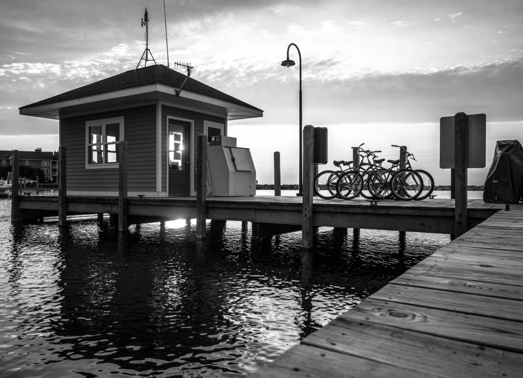 Long wooden dock, sunset on the Lake Michigan coast in black white
