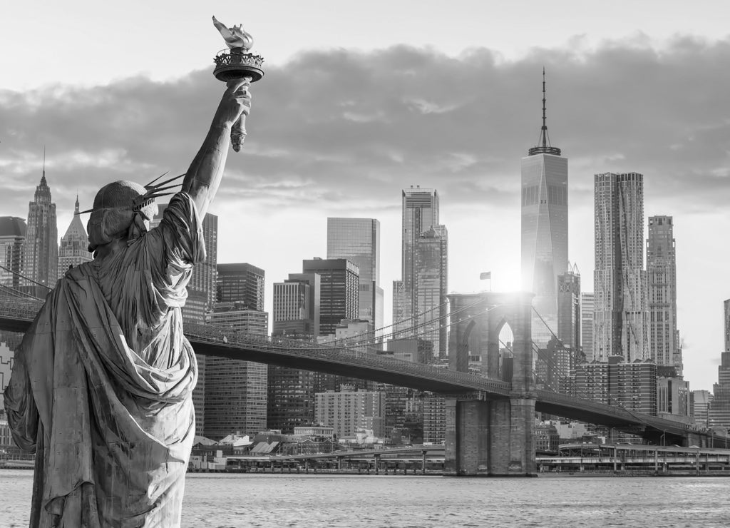Statue Liberty and New York city skyline at sunset in black white