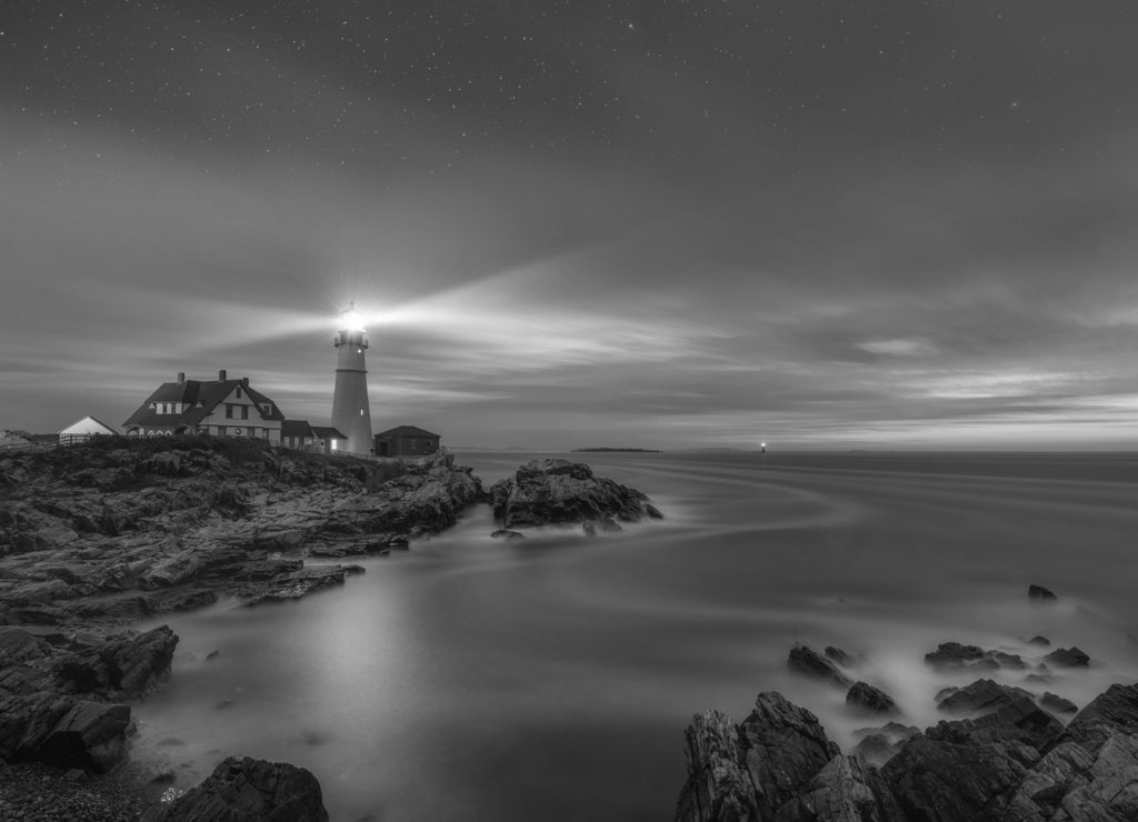 Night to day image of Portland Head Lighthouse at Cape Elizabeth, Maine in black white