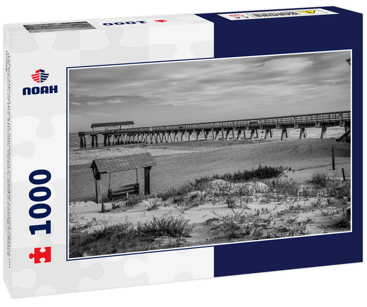 Tybee Island pier in Southern Georgia United States on the beach of the Atlantic Ocean, and a swing in black white