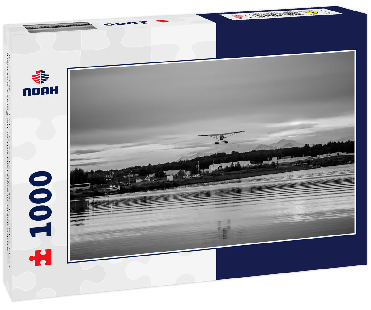 Sunset Over a Lake in Anchorage Alaska with a Float Airplane Taking off in the Distance in black white