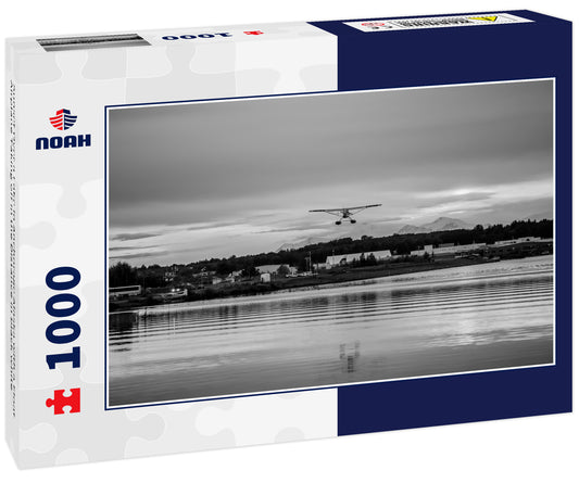 Sunset Over a Lake in Anchorage Alaska with a Float Airplane Taking off in the Distance in black white