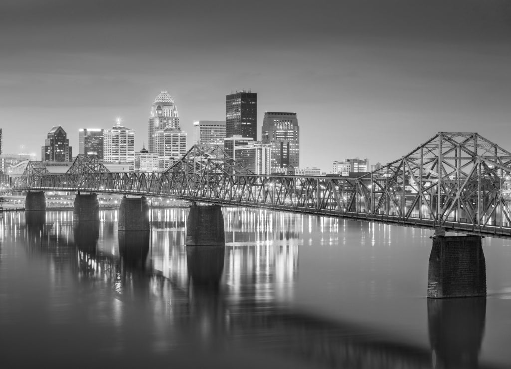 Louisville, Kentucky, USA downtown skyline on the Ohio River at dusk in black white