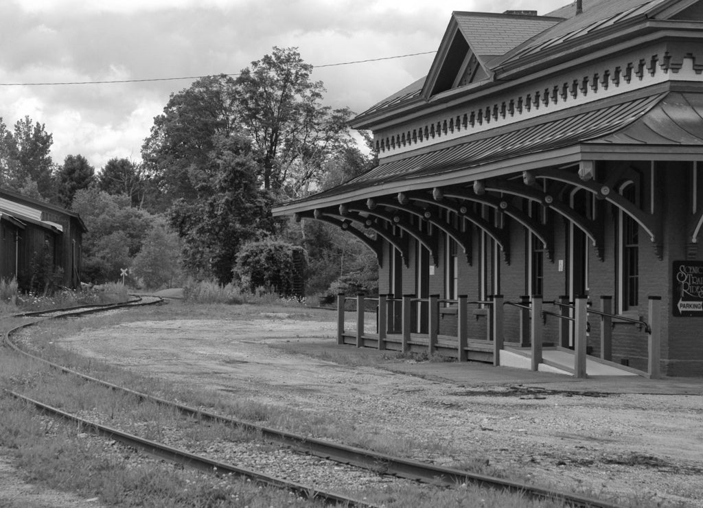 Old Train station in Vermont with overgrown tracks in black white
