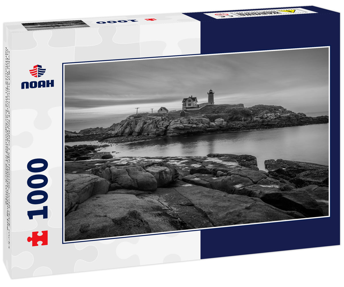 Colorful sunrise at Nubble Lighthouse, with dark rocks in the foreground and the rocky island hosting the lighthouse in the background in black white