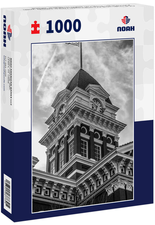 Old Indiana courthouse clock tower with American flag on pole in black white