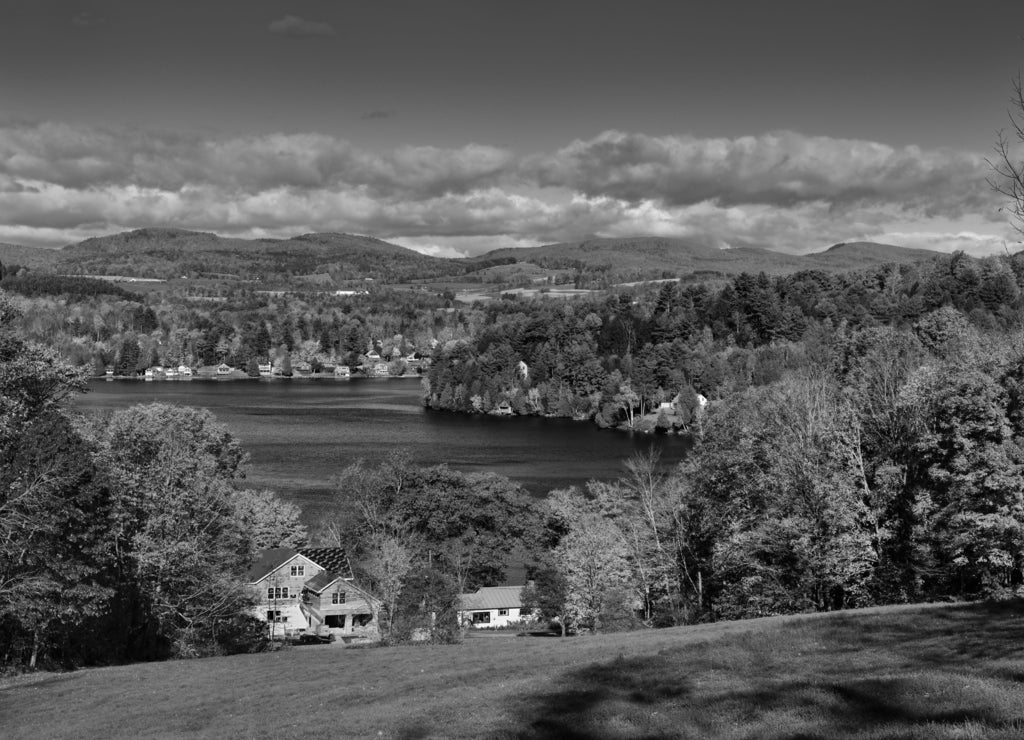 Cottages and houses on Harveys Lake West Barnet Vermont with trees in Fall color in black white