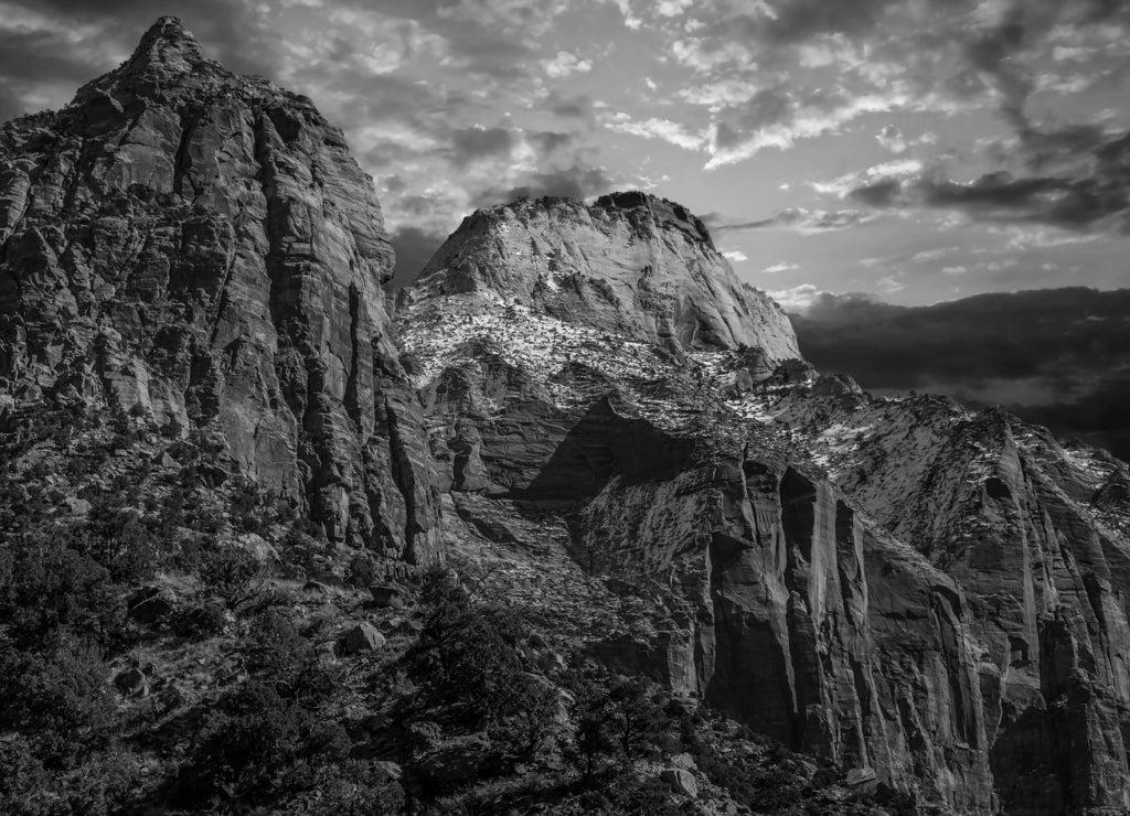 Mountains and cliffs and rock formations covered in snow along the scenic floor drive in Zion National Park, Springdale, Utah, USA in black white