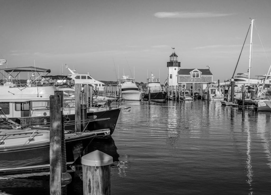 Summer evening at the marina with boats, sailboats, and lighthouse, Connecticut in black white