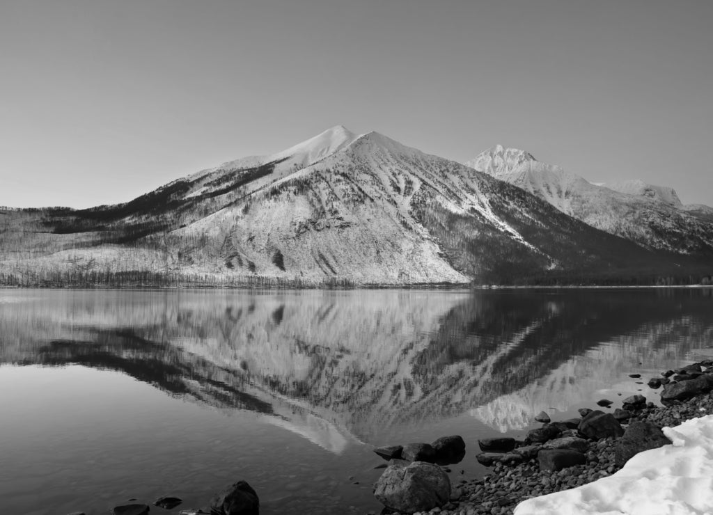 Lake McDonald sunset mountain peaks and reflection in Glacier National Park, Montana, USA in black white