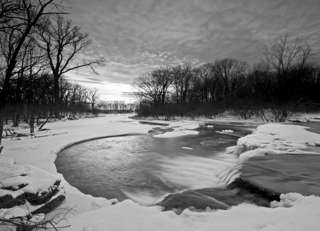 A winter sunset on a waterfall on Prairie Creek. Will County, Illinois, USA in black white