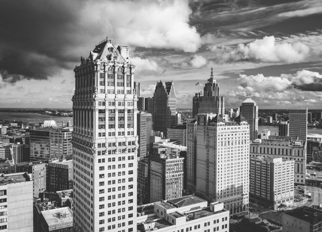 Cityscape of Detroit under the sunlight and a dark cloudy sky at daytime in Michigan in black white