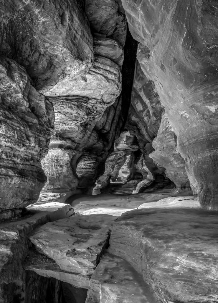 In Hocking Hills State Park, Ohio, Rock House is a twenty-five foot tall cave, on the side of a tall sandstone cliff, with seven natural Gothic-arched windows lighting its two hundred foot length in black white