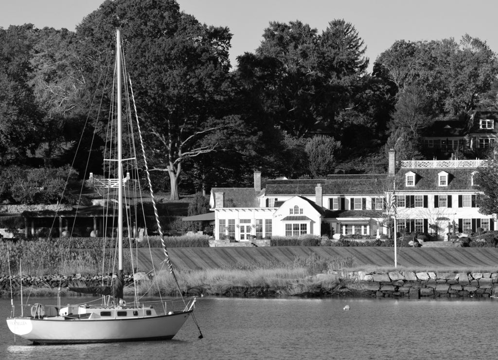 A rich life: A sailboat is moored at a luxury waterfront homes in Greenwich Connecticut, often considered one of the wealthiest towns in America in black white