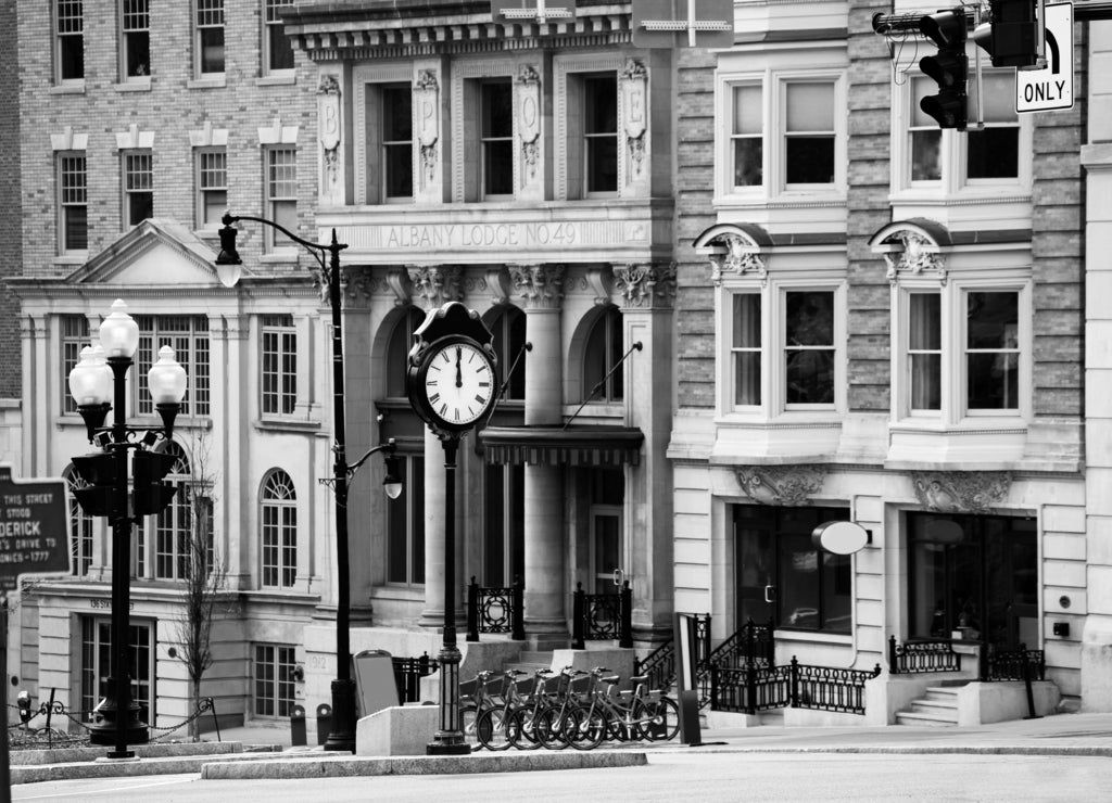 Outside clock on intersection of Eagle and State street in Albany, NY, USA in black white