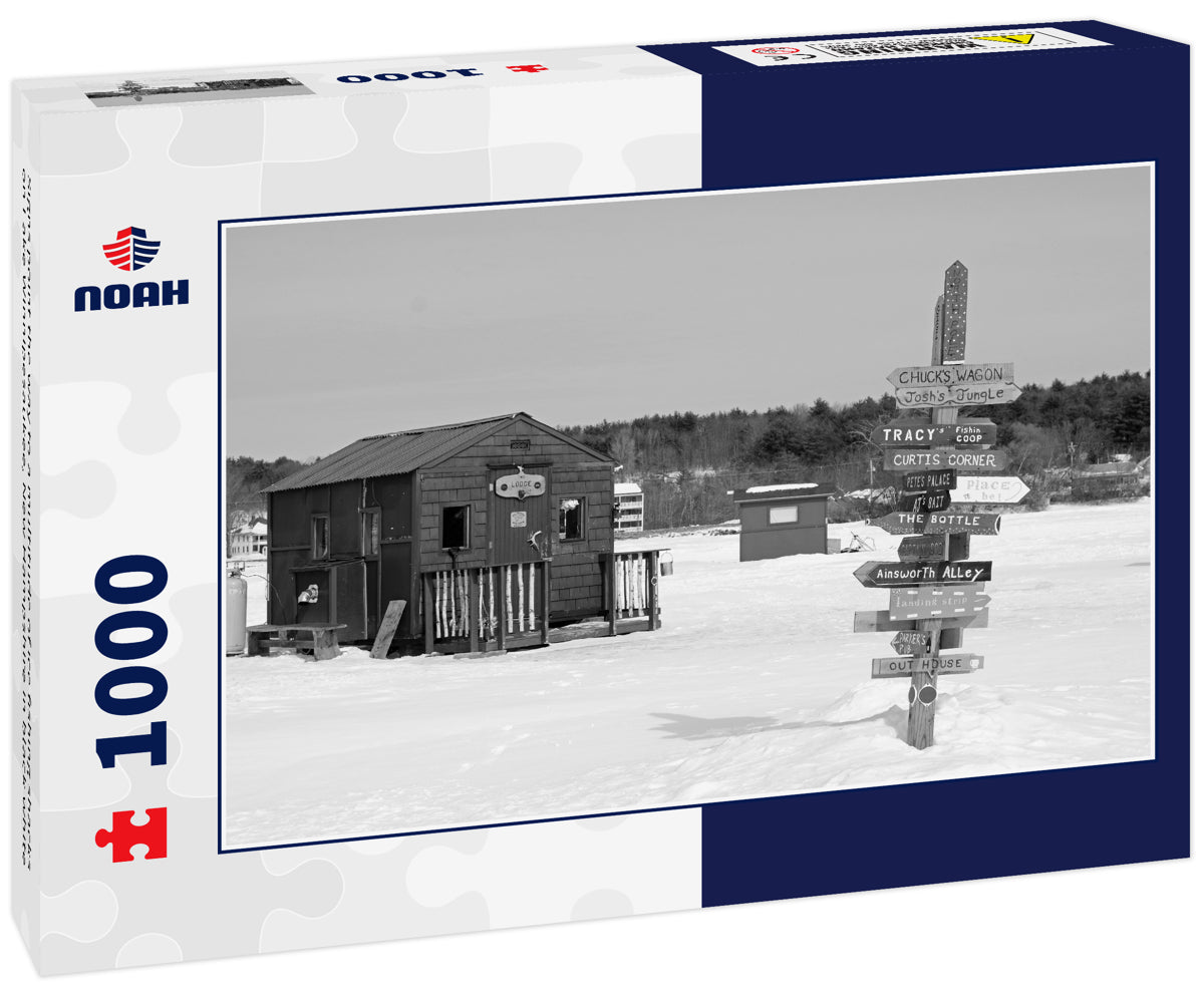 Signs point the way to a multitude of ice fishing shacks on Lake Winnipesaukee, New Hampshire in black white