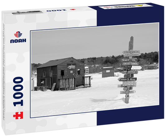 Signs point the way to a multitude of ice fishing shacks on Lake Winnipesaukee, New Hampshire in black white