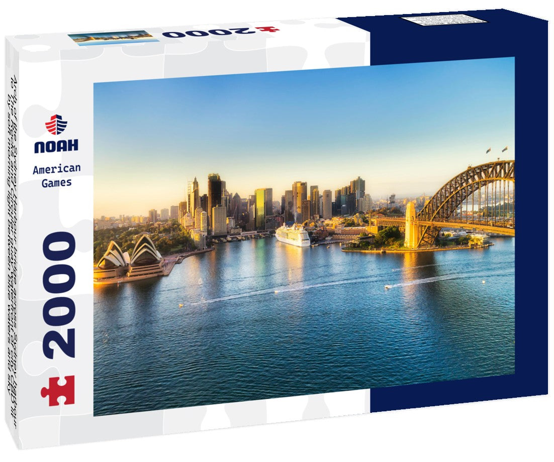 Arch of the Sydney Harbour bridge across Sydney harbour to The Rocks and Circular quay waterfront of city CBD lit by soft morning light between blue waters and sky 2000pc Puzzle
