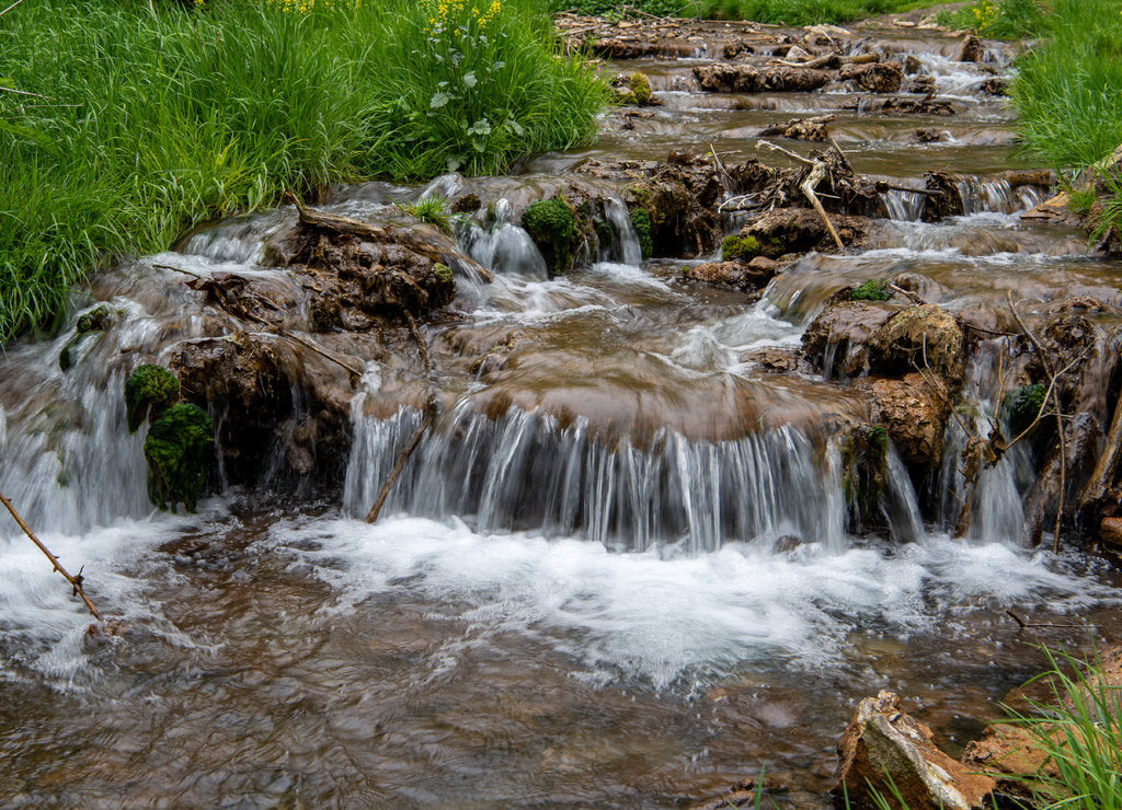A short little creek is cascading out of the Dunning's Springs Park in Decorah along the Driftless Area Scenic Byway in Iowa, USA