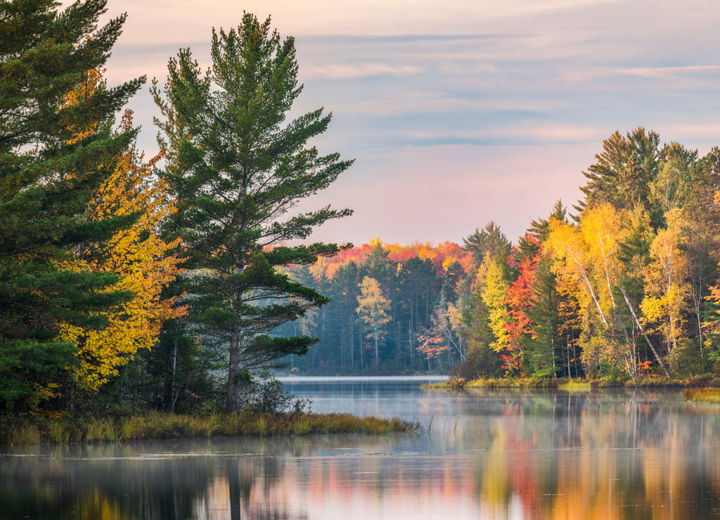 Autumn sunrise reflection on mirrored lake, Upper Peninsula of Michigan