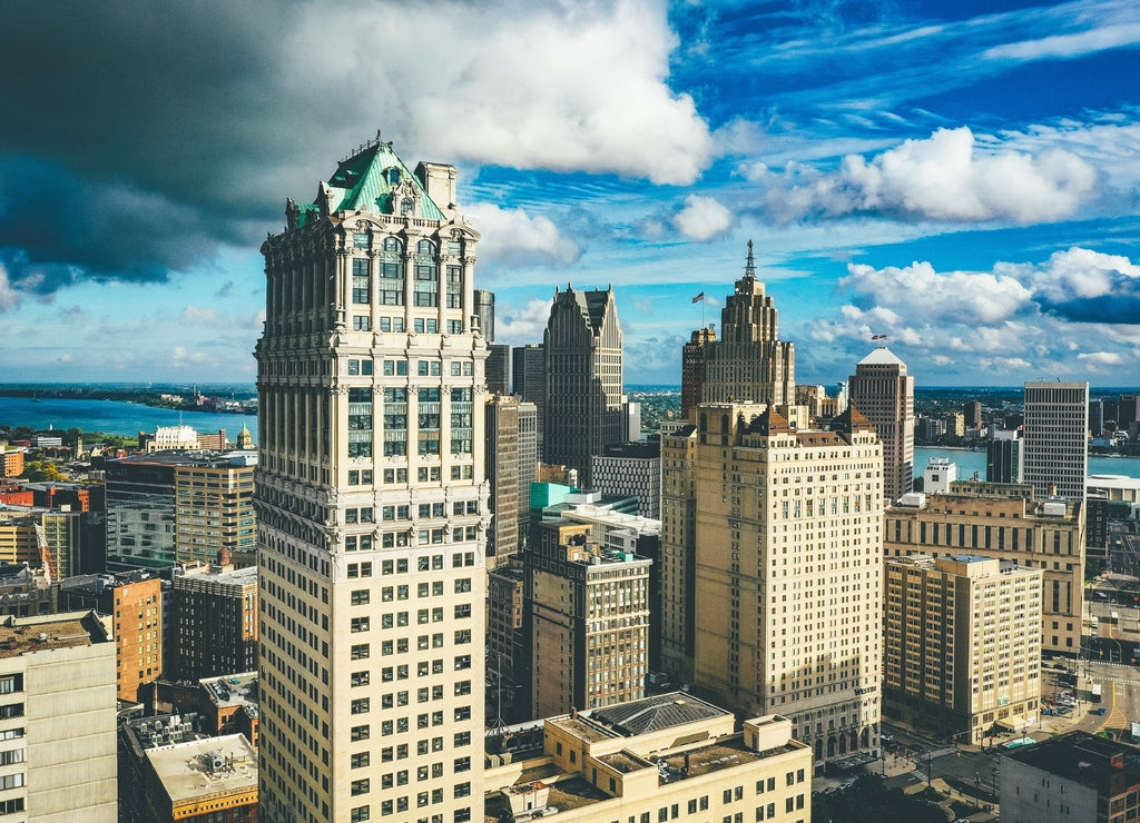 Cityscape of Detroit under the sunlight and a dark cloudy sky at daytime in Michigan