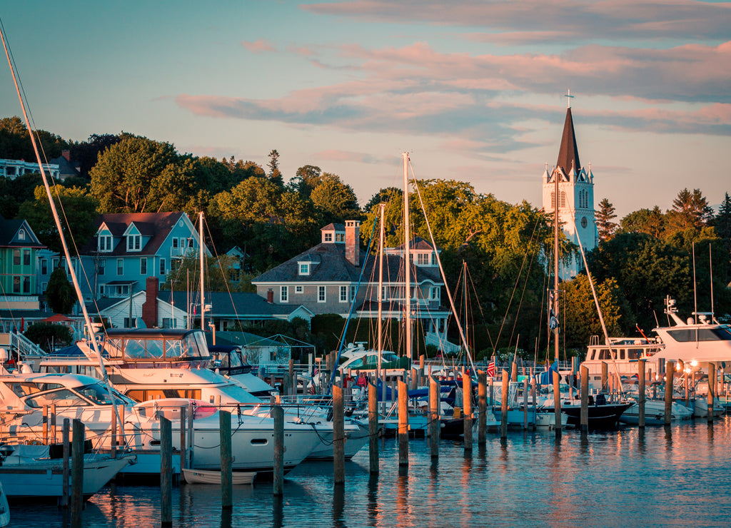 The Marina at Mackinac Island with Saint Anne's church and the historic Victorian houses a sunset shot from Lake Michigan