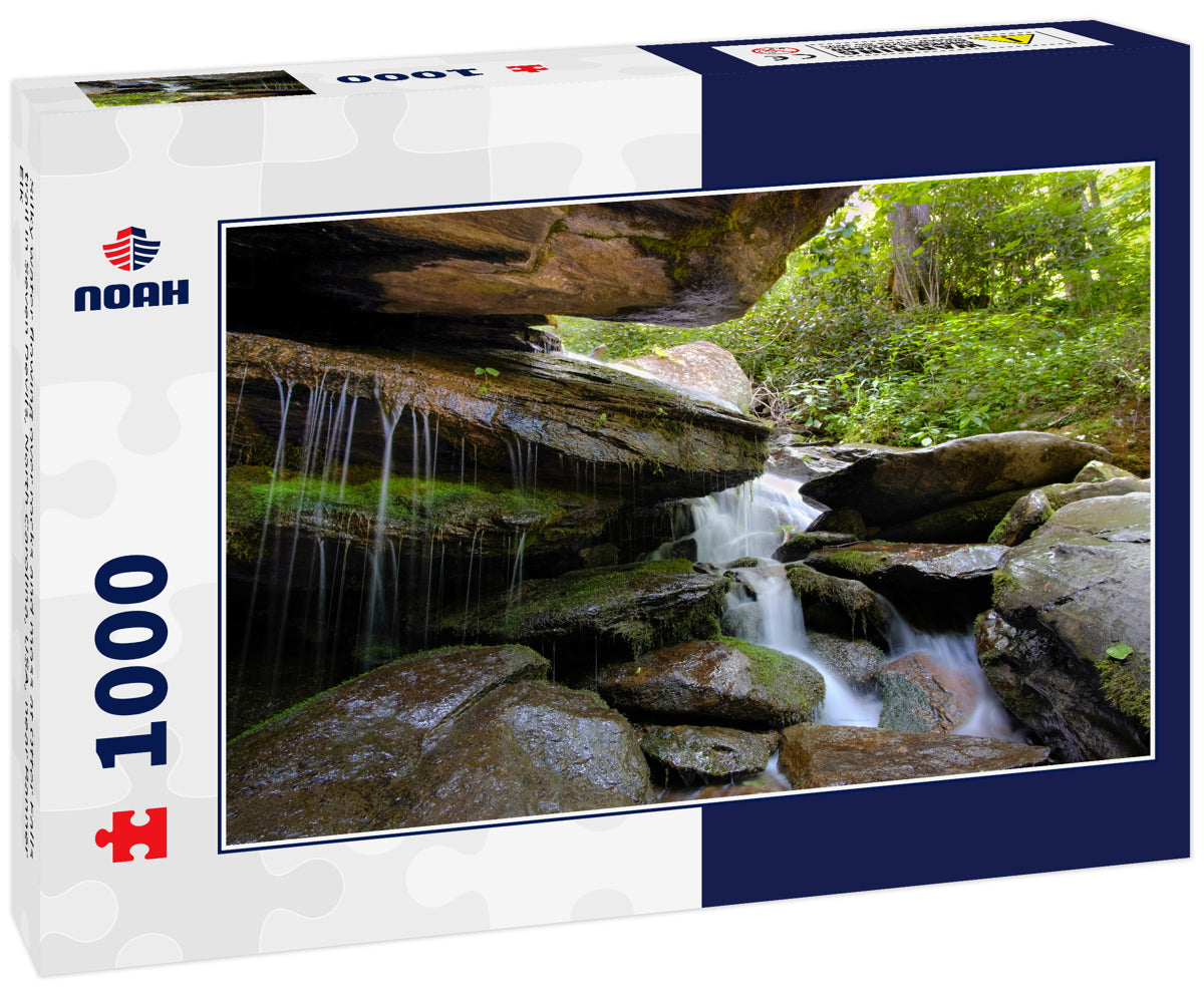 Silky water flowing over rocks and moss at Otter Falls trail in Seven Devils, North Carolina, USA, near Banner Elk