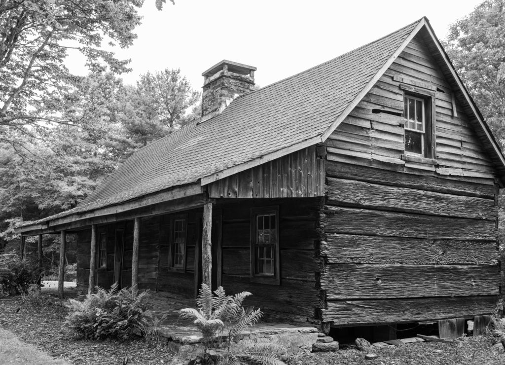 An old dilapidated broken down vacant home with broken windows in rural Western North Carolina