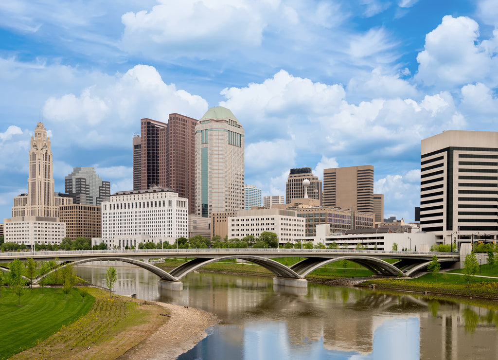 Beautiful skyline of Columbus Ohio with bridge and water reflection