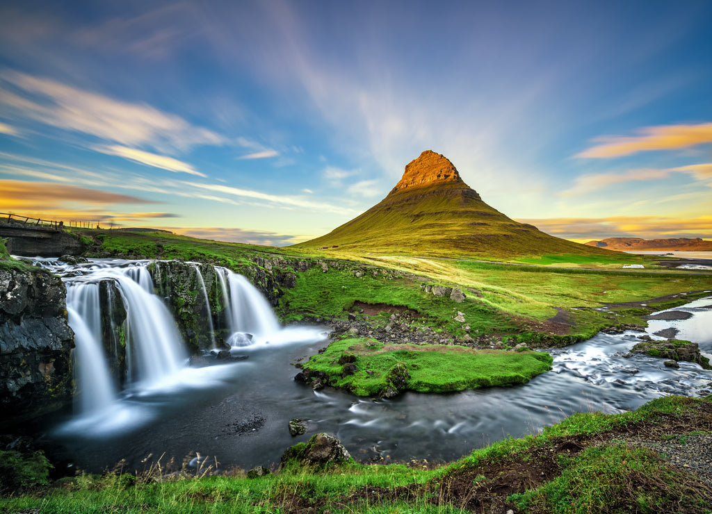 Sunset over Kirkjufellsfoss waterfall and Kirkjufell mountain in Iceland