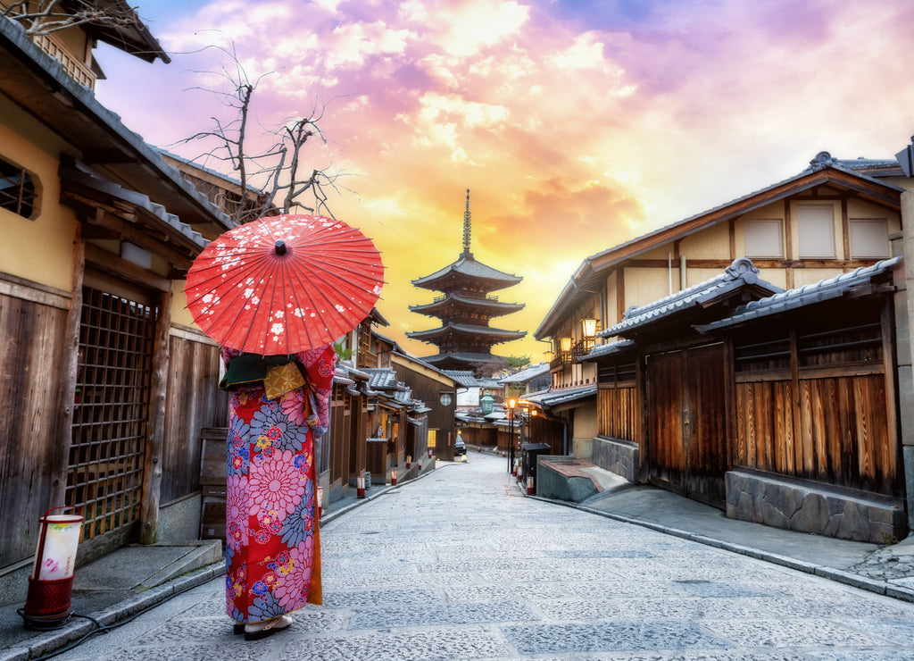 Young woman wearing traditional Japanese kimono with Japanese umbrella at Yasaka Pagoda and Sannen Zaka Street in Kyoto, Japan