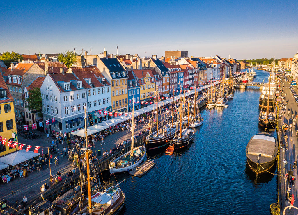 Amazing historical city center. Nyhavn New Harbour canal and entertainment district in Copenhagen, Denmark. The canal is home to many historic wooden ships. Aerial view from above