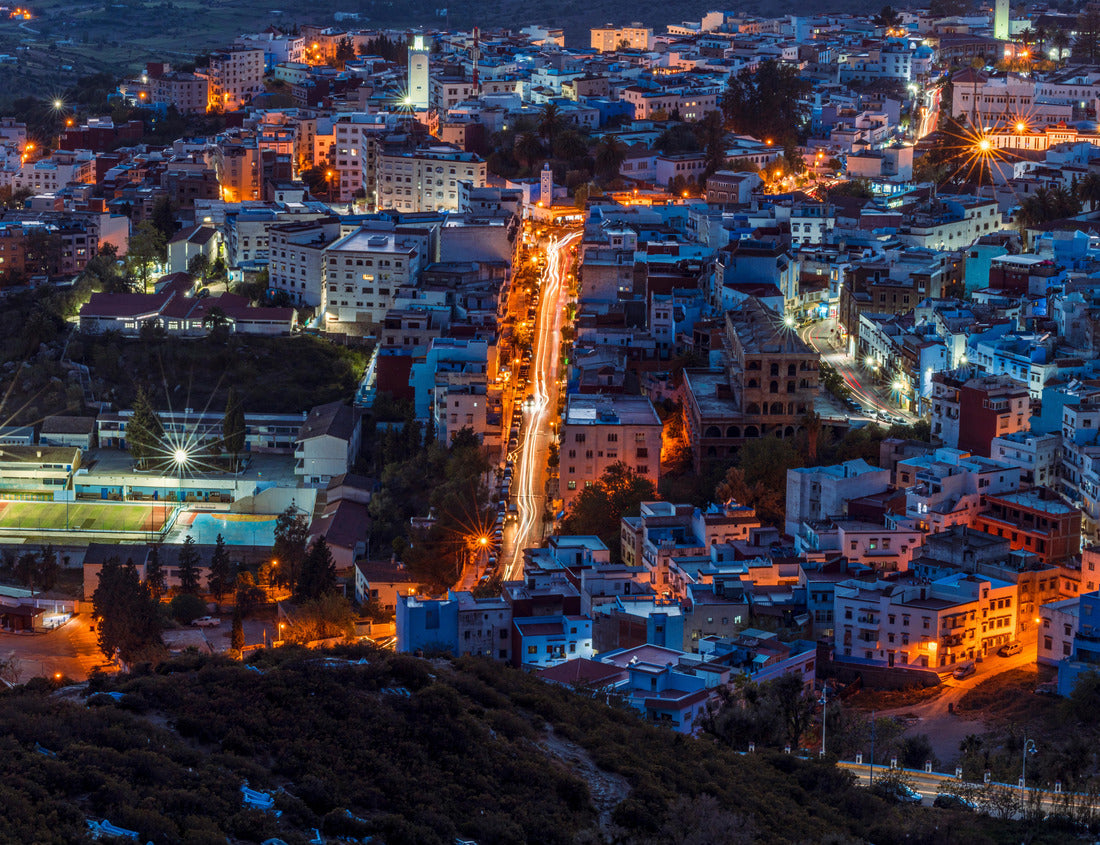 The vibrant town of Chefchaouen, nestled in the Rif Mountains of Morocco, comes alive at night with a dazzling display of lights. The iconic blue-washed buildings create a magical and picturesque view 1000pc Puzzle