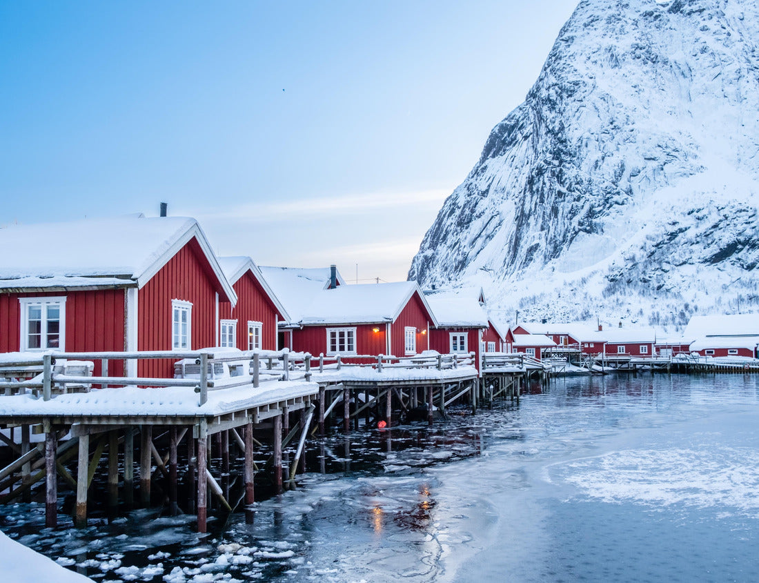 Reine village with traditional rorbu houses on Lofoten islands in winter. Scandinavian landscape with red wooden fishermen cabins on frozen sea water and snowy Reinebringen mountain, northern Norway 1000pc Puzzle