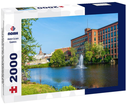 Noah Jigsaw Puzzle Fountain on the Nashua River against the background of a historic cotton factory building with a clock tower in the old industrial park of Nashua. New Hampshire, USA 2000 pieces