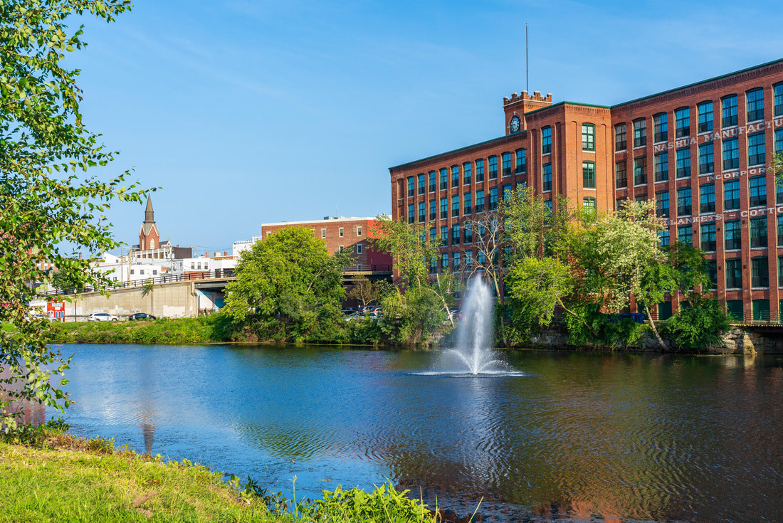 Noah Jigsaw Puzzle Fountain on the Nashua River against the background of a historic cotton factory building with a clock tower in the old industrial park of Nashua. New Hampshire, USA 2000 pieces