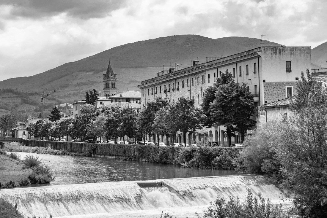 Noah Jigsaw Puzzle A view of Foligno, crossed by the river Topino, a bell tower rises above the roofs of the houses. The cloudy sky at sunset in black white 2000 pieces