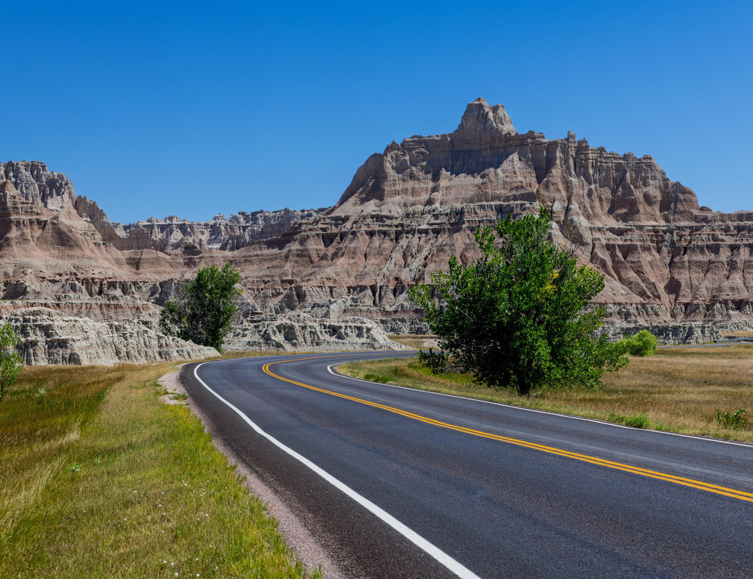 Noah Jigsaw Puzzle A highway leads through a beautiful grassy landscape to a colorful peak in Badlands National Park, South Dakota 1000 Pieces