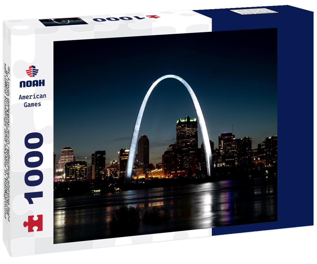 St. Louis gateway arch reflecting shining light at night on Mississippi River in foreground, tall office buildings and skyline in background 1000pc Puzzle