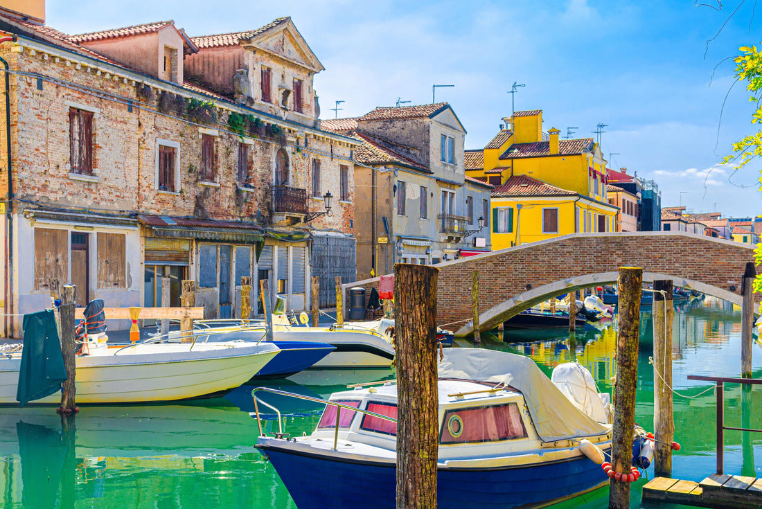 Chioggia cityscape with narrow water canal with colorful multicolored boats and yachts between old colorful buildings and brick bridge, blue sky background in summer, Veneto region, northern Italy 2000pc Puzzle