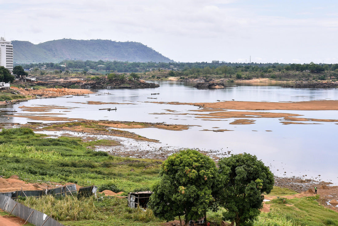 the Oubangui River in Bangui, Central African Republic, during the dry season, with boats, fishermen, sand-gathering laborers, and buildings on the banks of the river 2000pc Puzzle