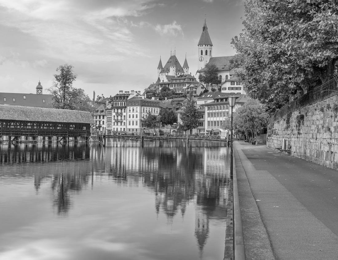 Noah Jigsaw Puzzle The towering red Navajo sandstone cliffs at Snow Canyon State Park. The breathtaking rock formations rise steeply from the grassy valley below. Taken in the early morning light - St George, Utah, USA in black white 1000 pieces
