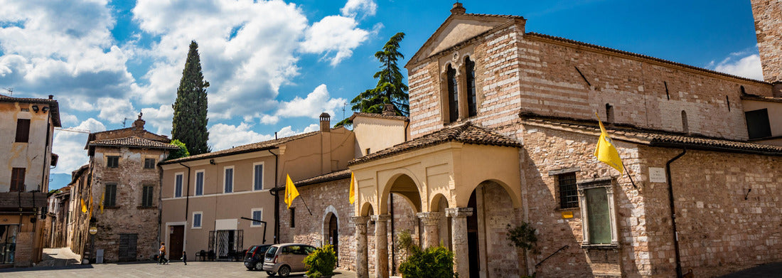 The Basilica of Santa Maria Infraportas, an old medieval church with tower. The yellow flag of one of the districts. In Foligno, Perugia, Umbria, Italy 1000pc Panoramic Puzzle