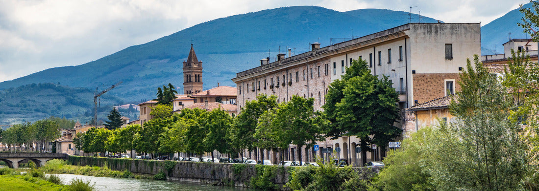 Noah Jigsaw Puzzle A view of Foligno, crossed by the river Topino, a bell tower rises above the roofs of the houses. The cloudy sky at sunset panorama 1000 pieces