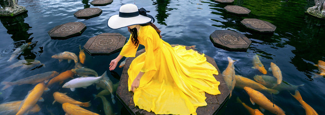 Noah Jigsaw Puzzle Woman feeding colorful fish in pond at Tirta Gangga Water Palace in Bali, Indonesia panorama 1000 pieces