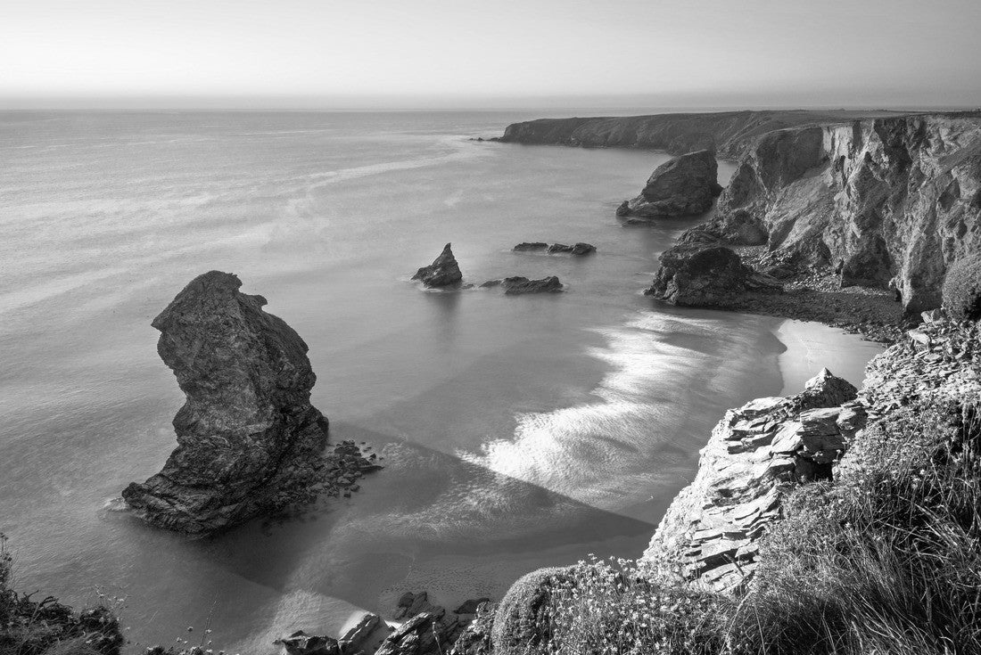 Sunset at Bedruthan Steps. Carnewas and Bedruthan Steps is a stretch of coastline located on the north Cornish coast between Padstow and Newquay, in Cornwall, England, United Kingdom 2000pc PuzzleBlack and White