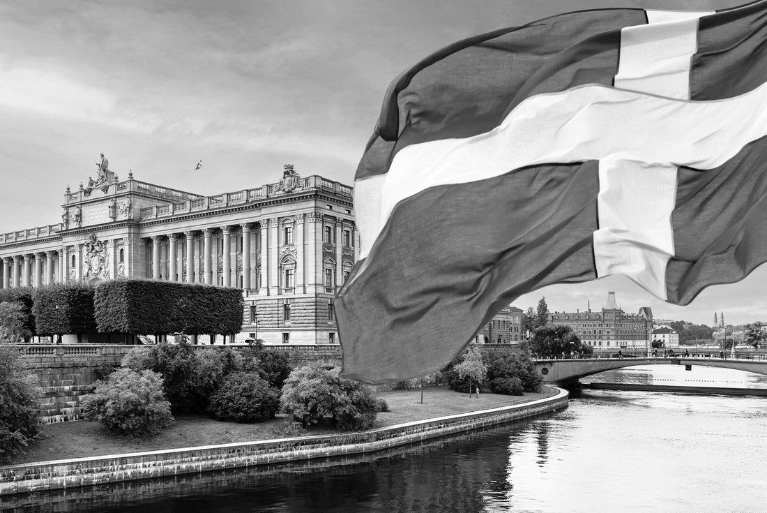 Swedish Parliament (Riksdag) and the Riksbank bridge over the Lilla Vartan river with the Swedish national flag in the foreground 2000pc PuzzleBlack and White