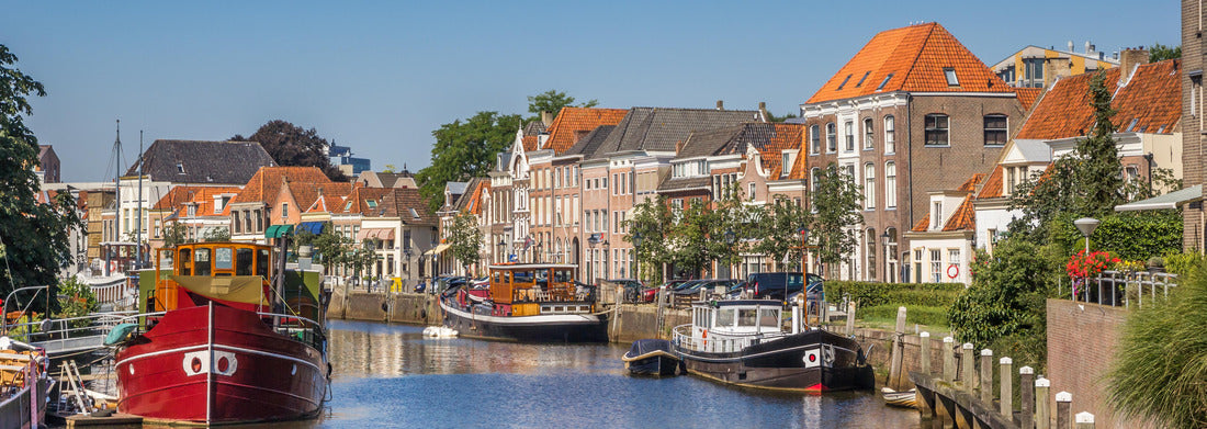 a canal with old ships and historic houses in Zwolle, Netherlands 1000pc Panoramic Puzzle