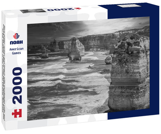 Noah Jigsaw Puzzle Blue green ocean and beach with sandbanks cliffs and waves with close view of The twelve apostles and cliffs in the shadow of the sunset in Victoria, Australia against a orange cloudy sky in black white 2000 pieces