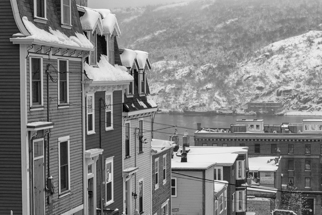 A very steep street in St. John's, Newfoundland, on a foggy winter's day, with bright colored row houses descending down the road. There's snow on the hillside in the background and a smooth harbor 2000pc PuzzleBlack and White